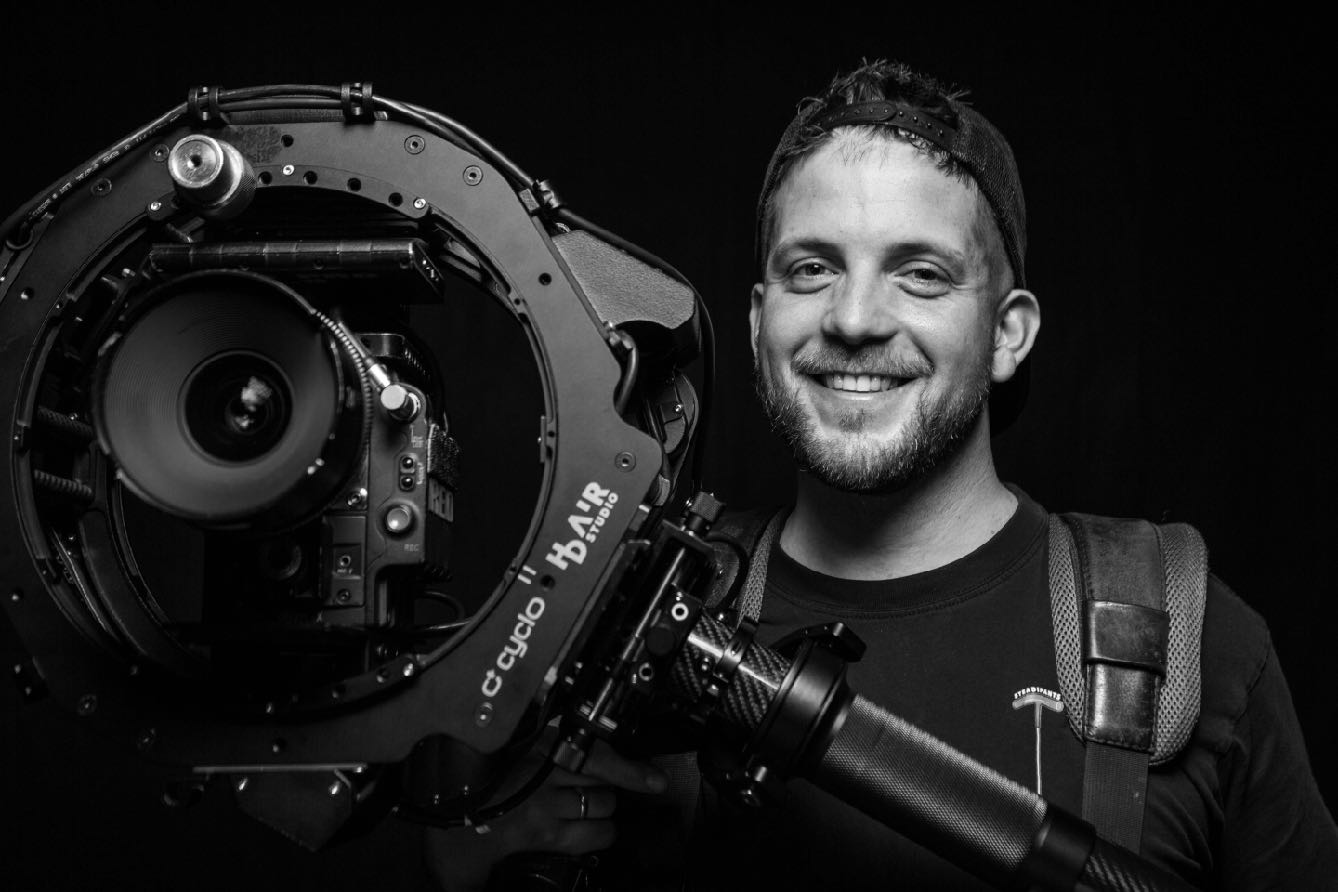 Portrait of Adam Mendry with a cinema camera