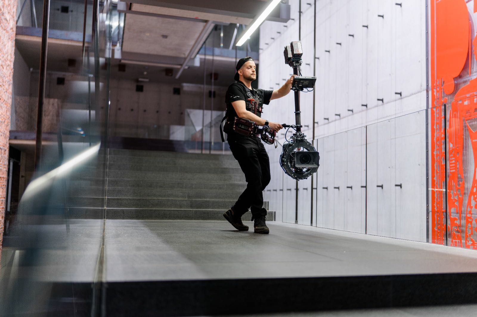 Adam Mendry operating a stabilized camera on location